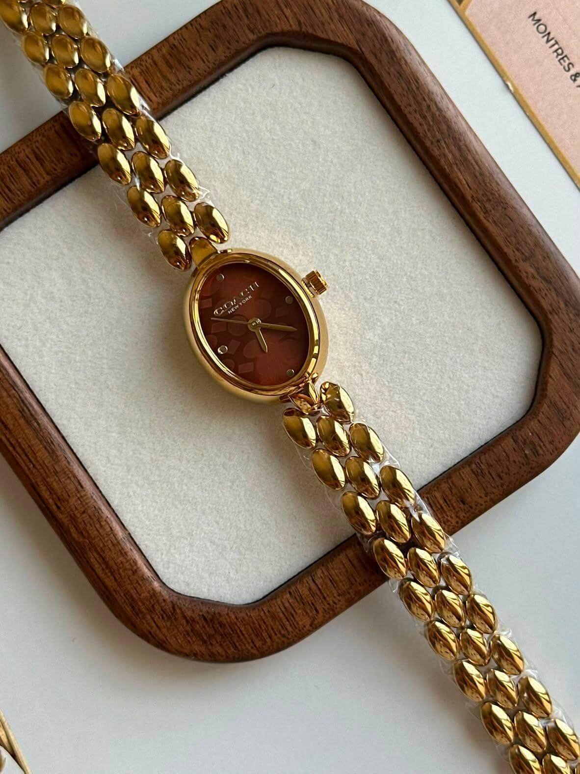 Montre Coach en acier doré